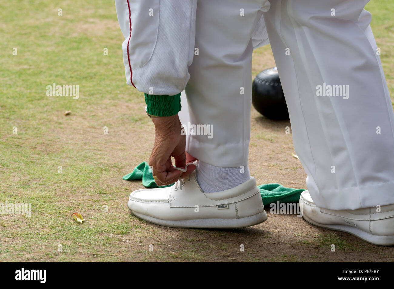 A competitor tying their shoelace at the national women`s lawn bowls championships, Leamington Spa, UK Stock Photo